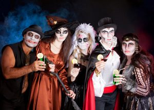 Adults in Halloween costumes